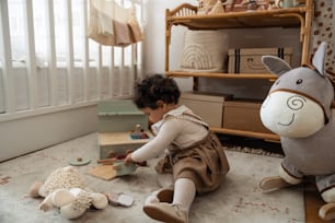 a small child playing with toys in a room