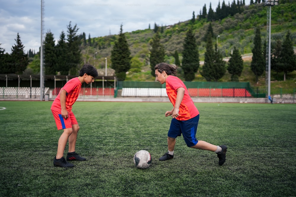 a couple of kids playing a game of soccer