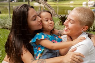 a woman holding a little girl in her arms