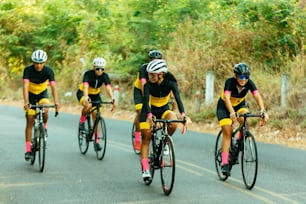 a group of people riding bikes down a road