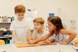 a group of young children sitting at a table