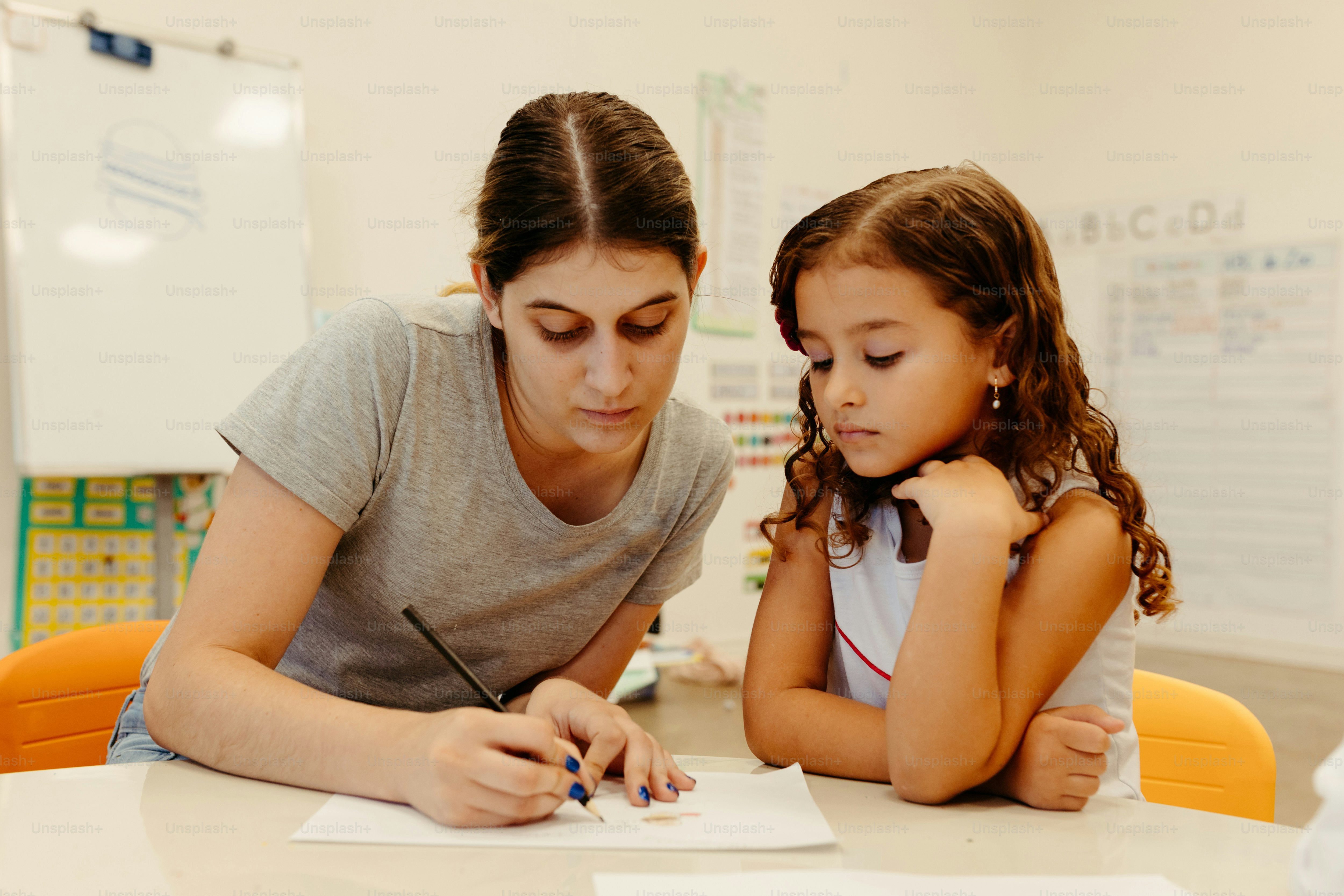 a woman and a little girl sitting at a table