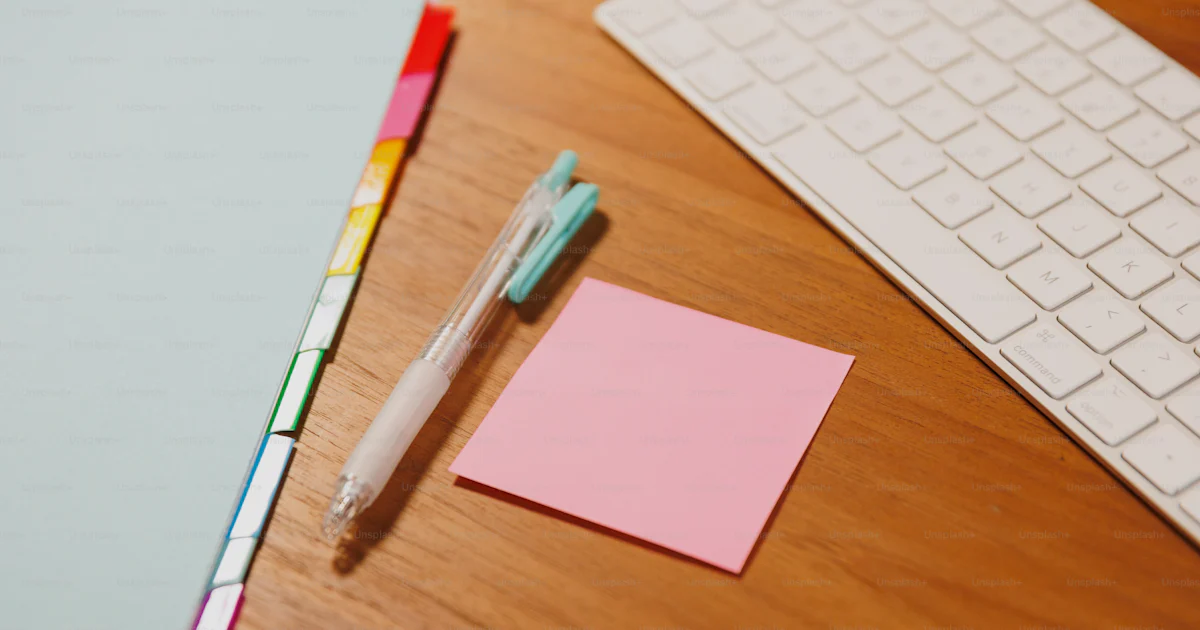 Key Desk Note A pen and sticky note sitting on a desk next to a keyboard photo ...