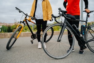 a man and a woman standing next to their bikes