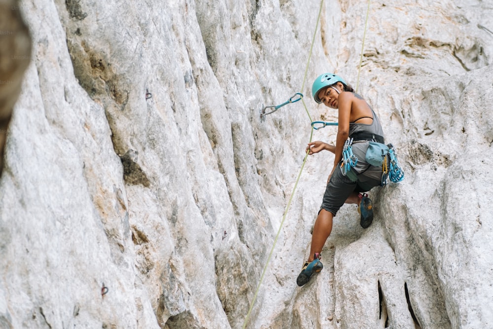 a man climbing up the side of a mountain