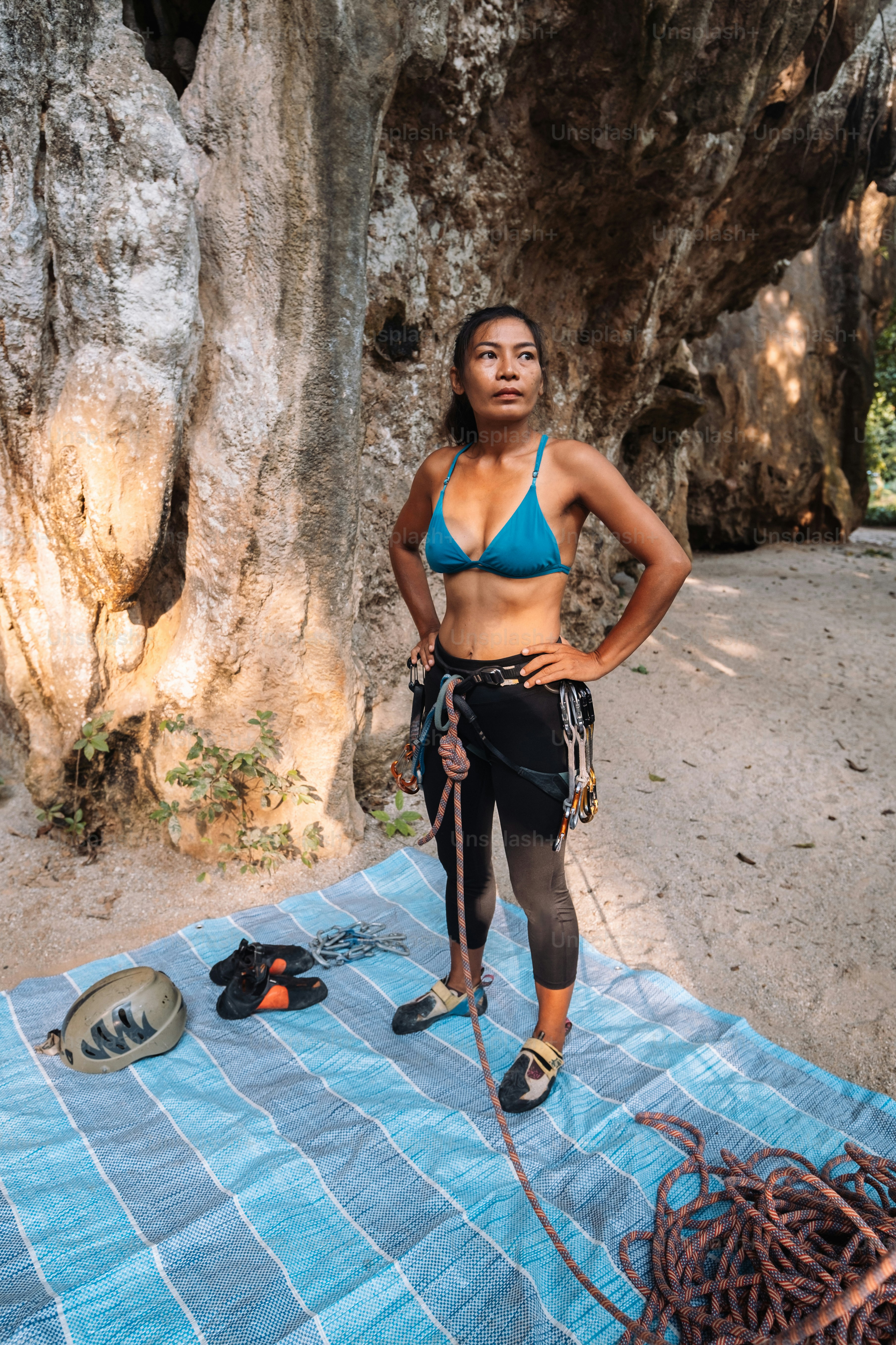 a woman in a bikini standing on a towel