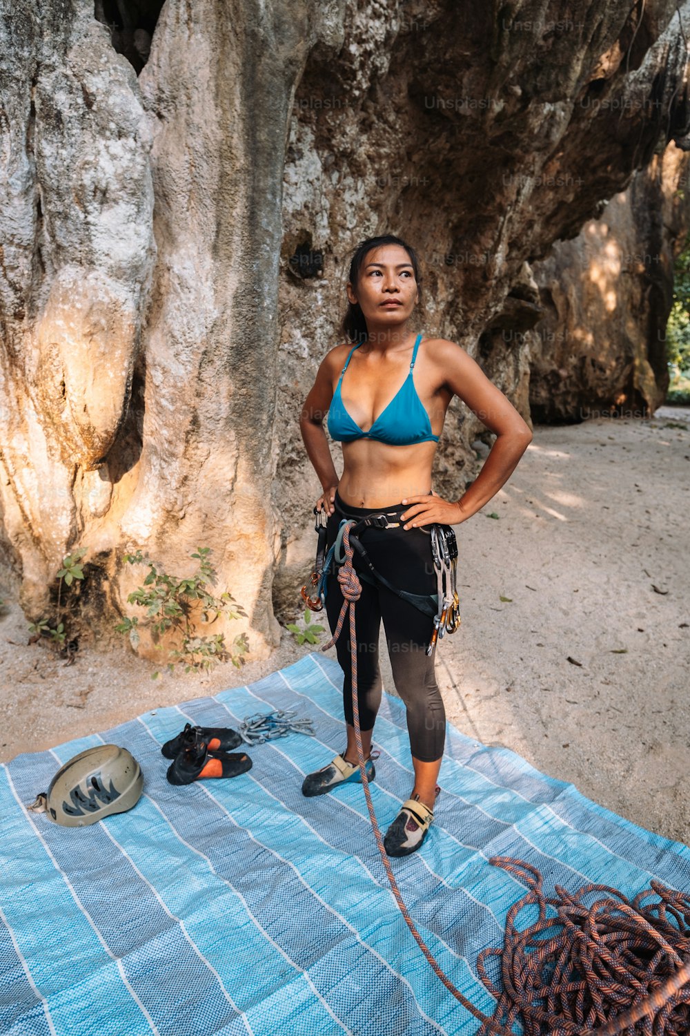 a woman in a bikini standing on a towel