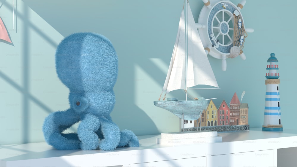 a blue stuffed animal sitting on top of a white shelf