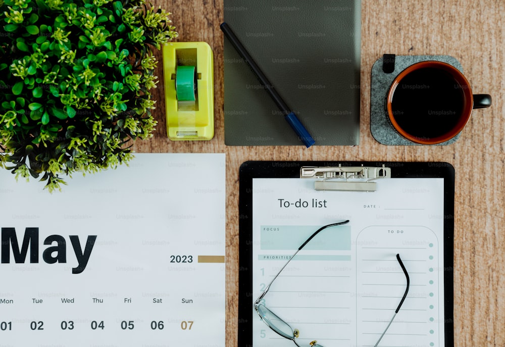 a desk with a clipboard and a clipboard with a calendar on it