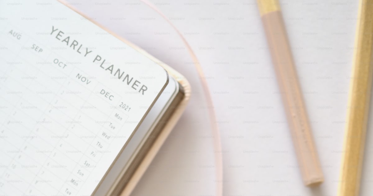 A notebook, pencils, and a planner on a table photo – Daily routine ...