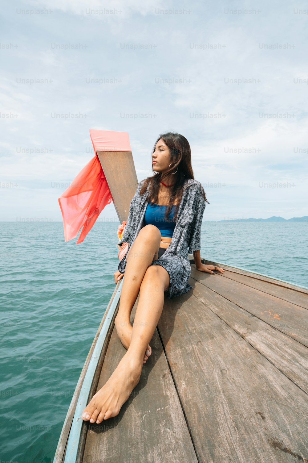 a woman is sitting on a boat in the water