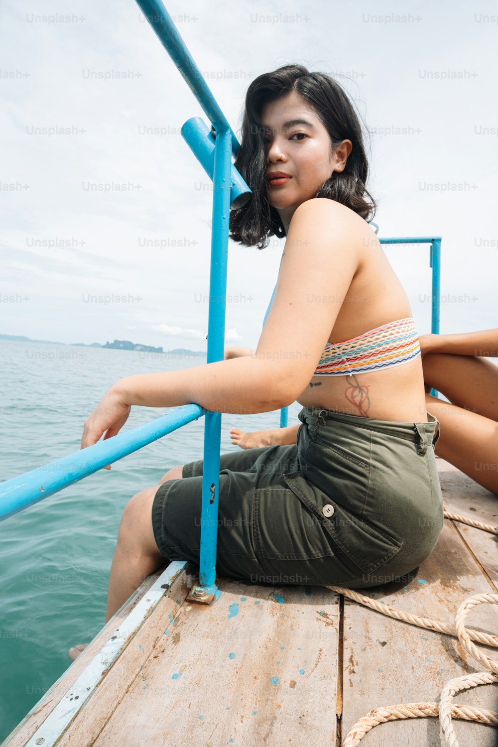 a woman is sitting on a boat in the water