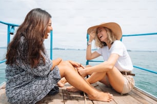 two women sitting on a boat talking to each other