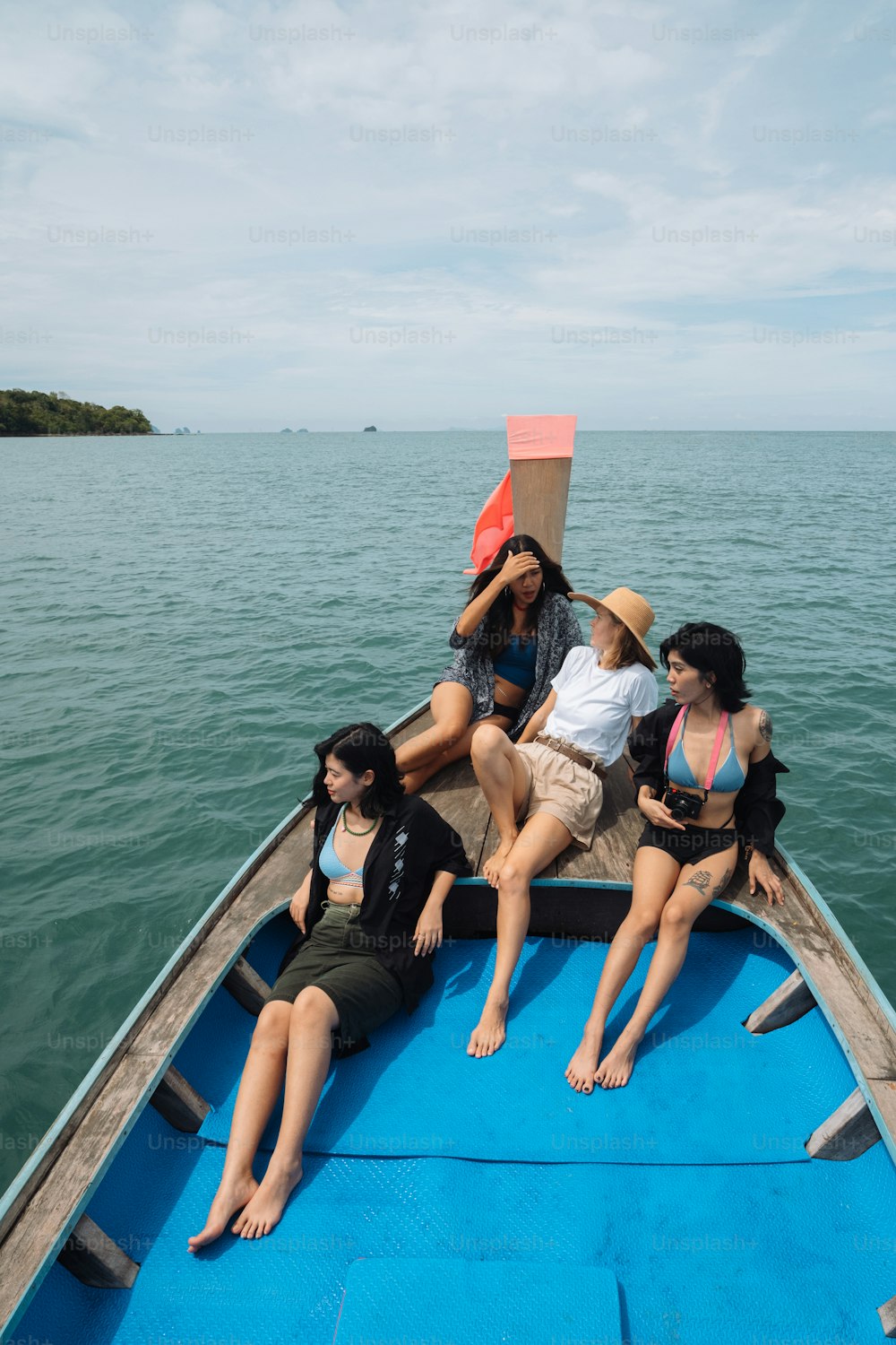 a group of women sitting on the back of a boat
