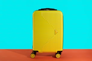 a yellow piece of luggage sitting on top of a table