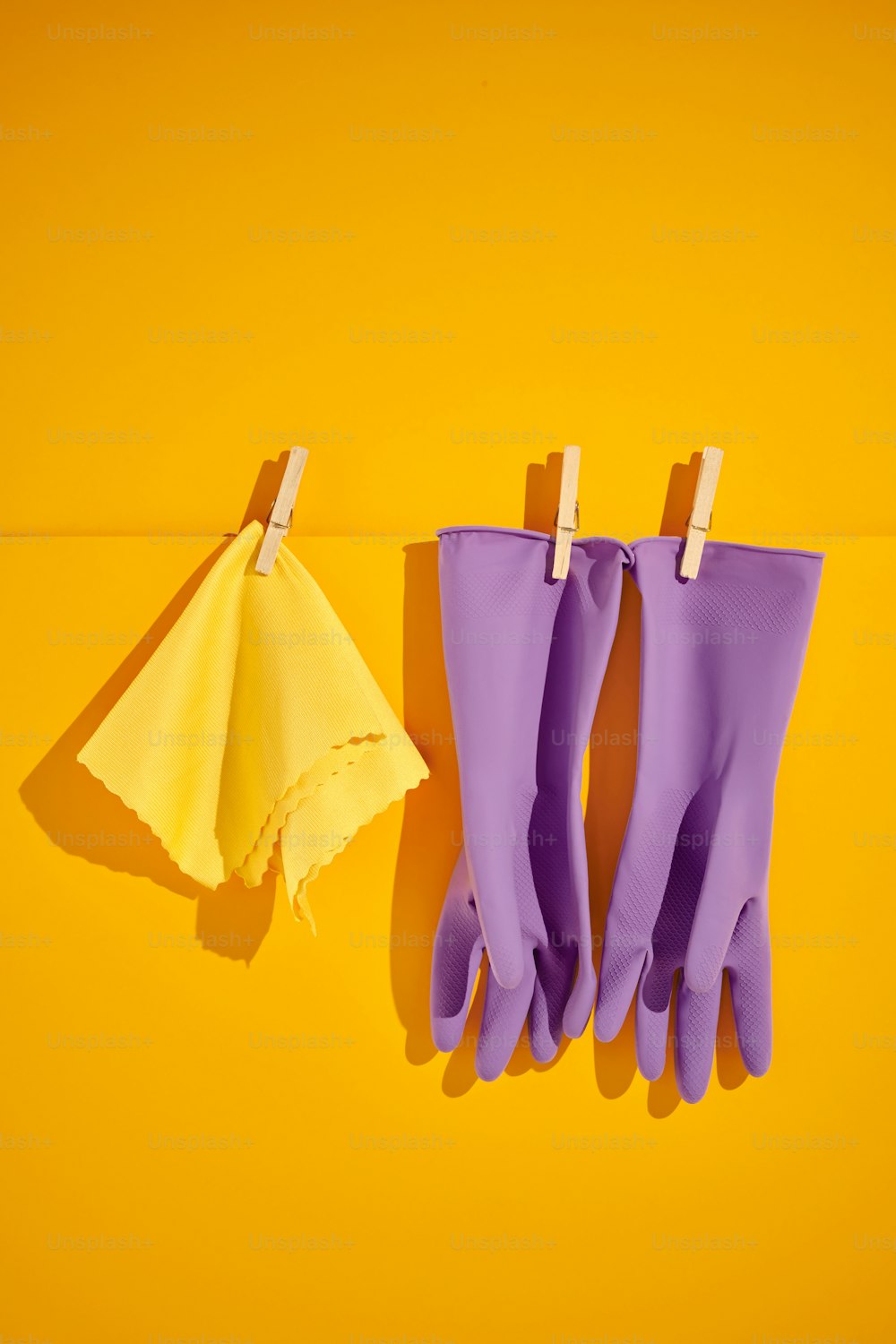 a pair of purple gloves hanging on a clothes line