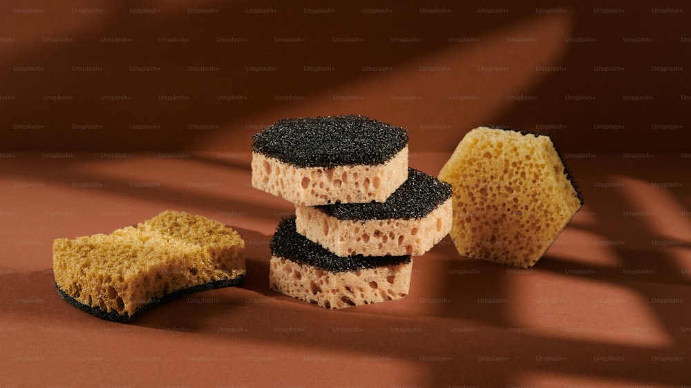 a group of sponges sitting on top of a brown surface