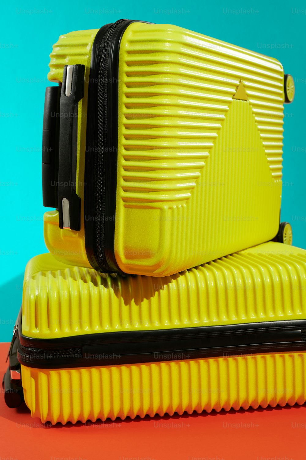 two pieces of yellow luggage sitting on top of each other