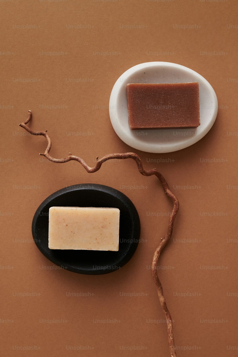 a piece of soap sitting on top of a black plate