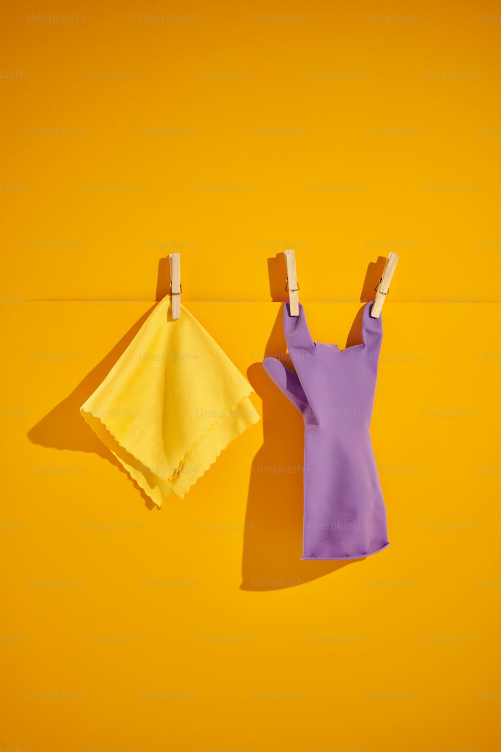 clothes hanging on clothes pins on a yellow background