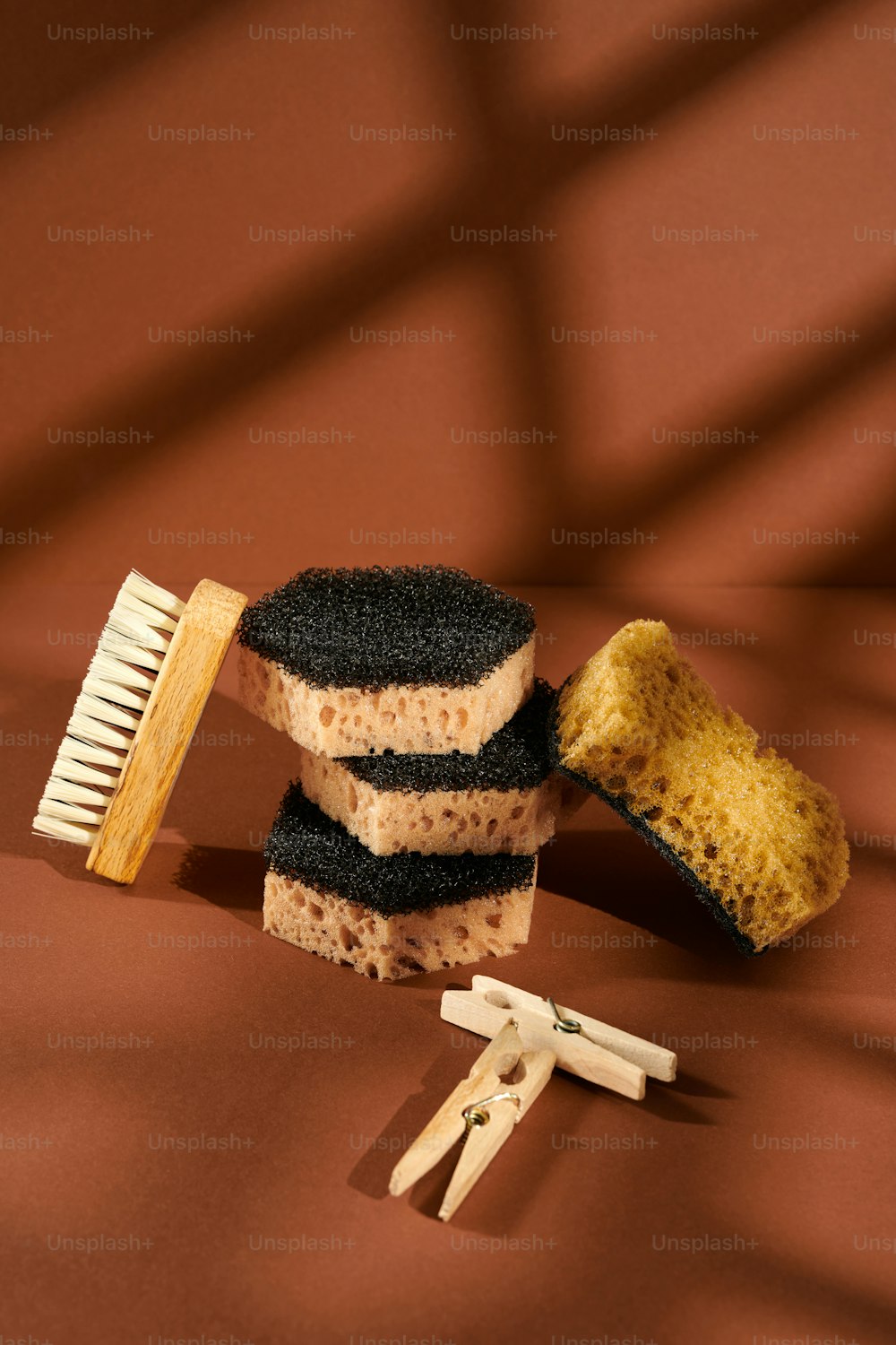 a comb, sponge, and other items on a brown surface