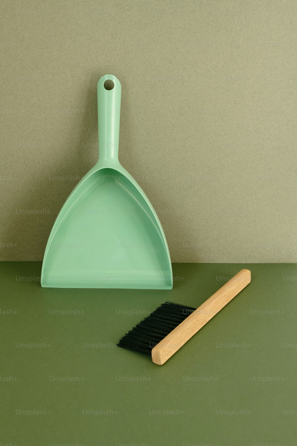 a broom and dustpan sitting on a table