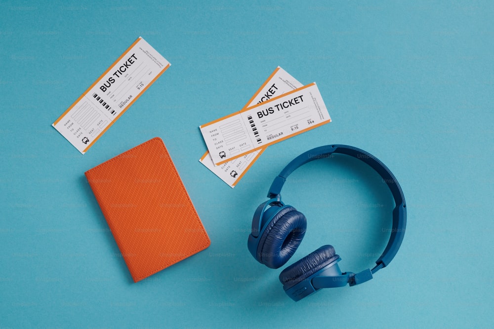 a pair of headphones sitting next to a pair of tickets