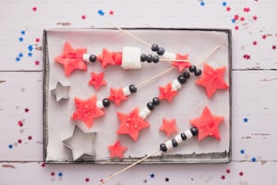 a tray of red, white and blue stars on a stick
