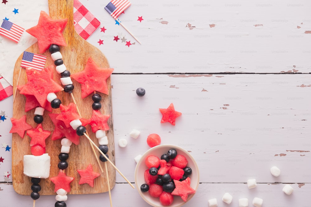a wooden cutting board topped with red, white and blue stars