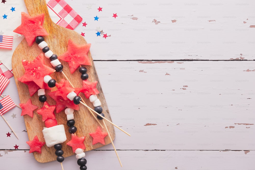 a wooden cutting board topped with red and white stars