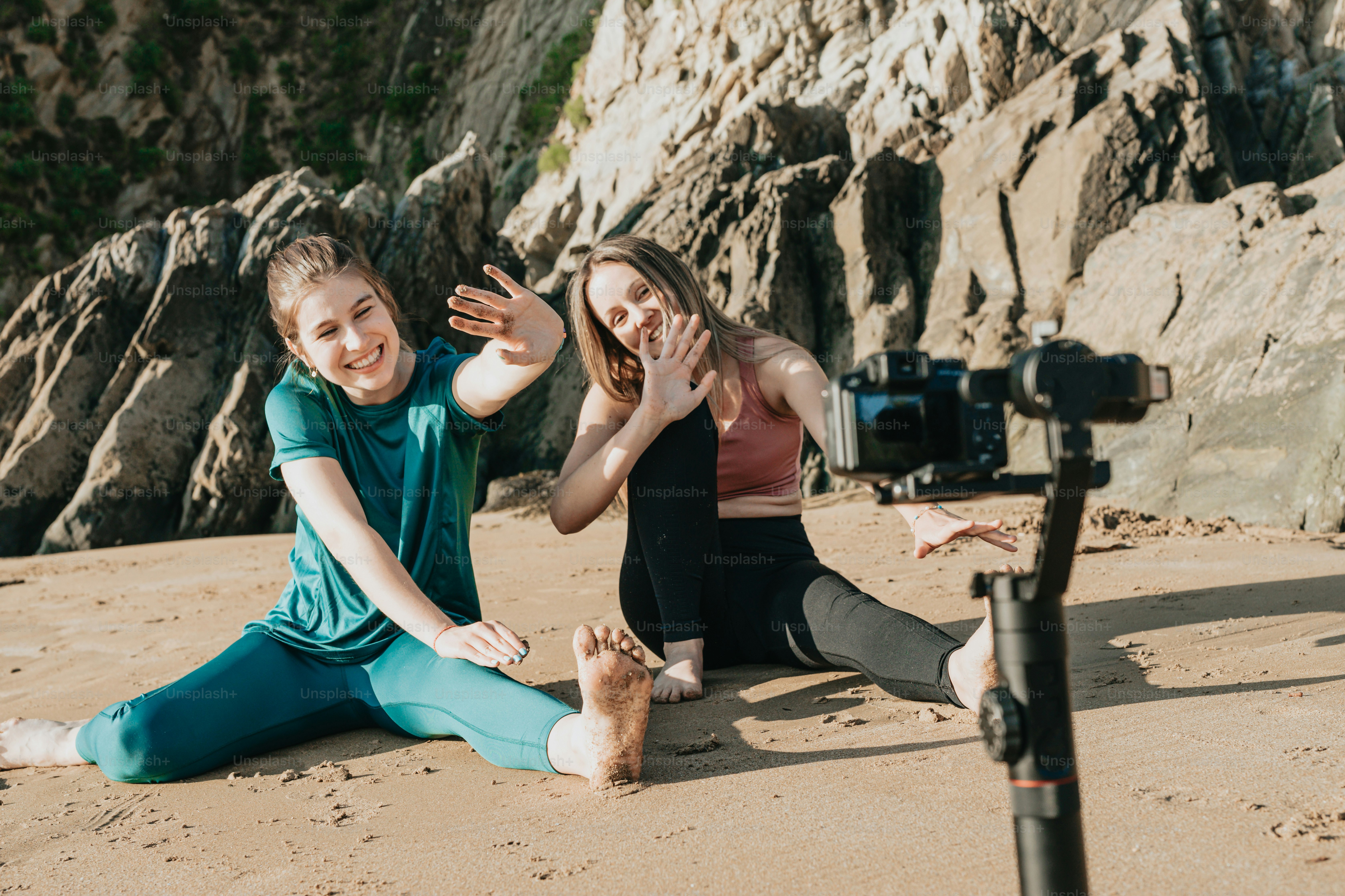 a couple of people that are sitting in the sand