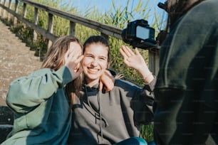 a couple of women sitting next to each other