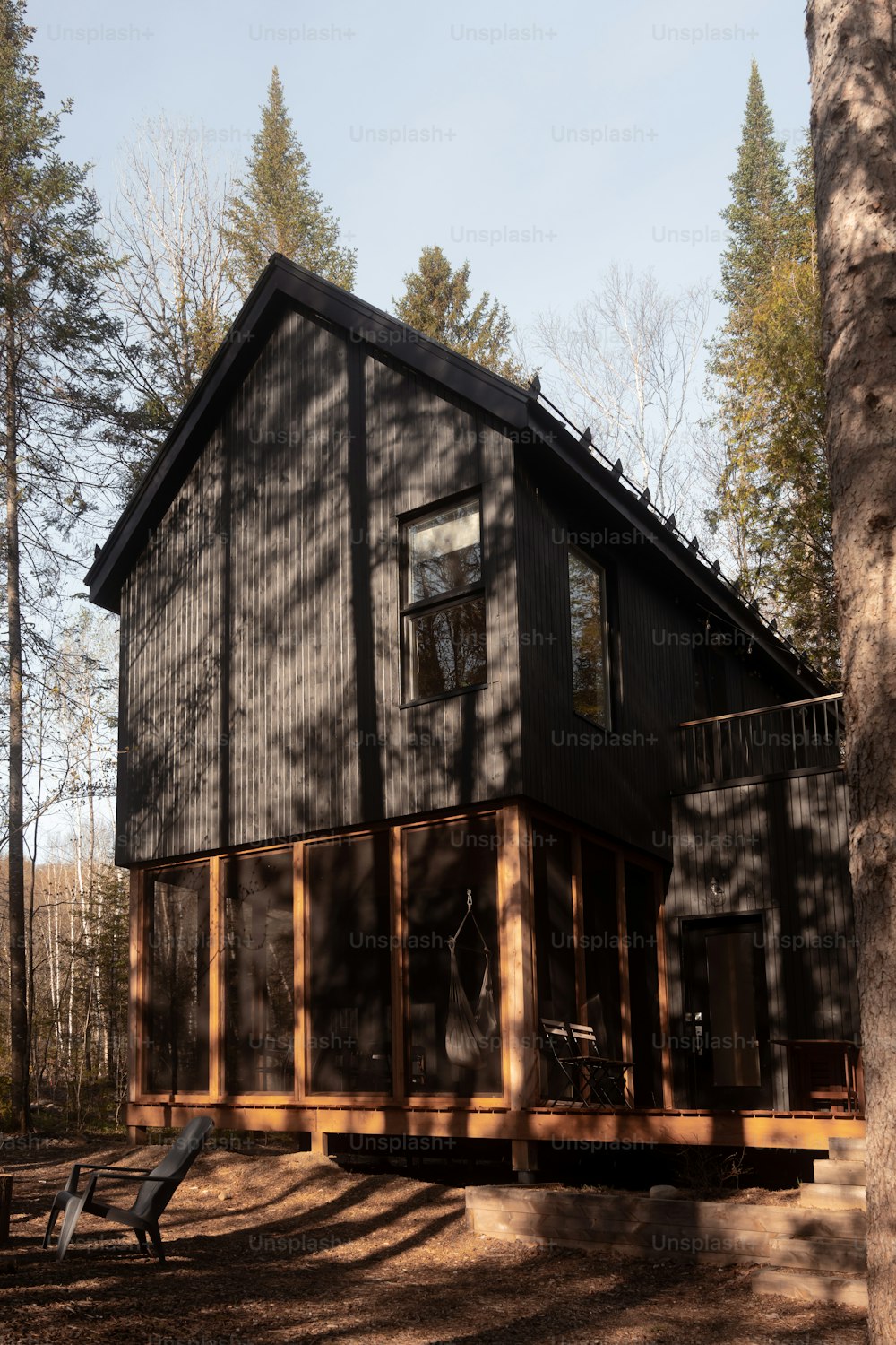 a house with a deck and a picnic table in front of it