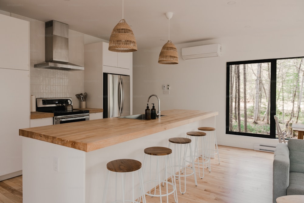 a kitchen with a bar and stools in it