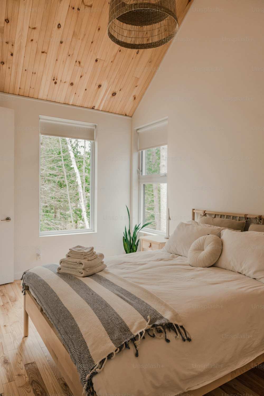 a bedroom with a bed and two windows