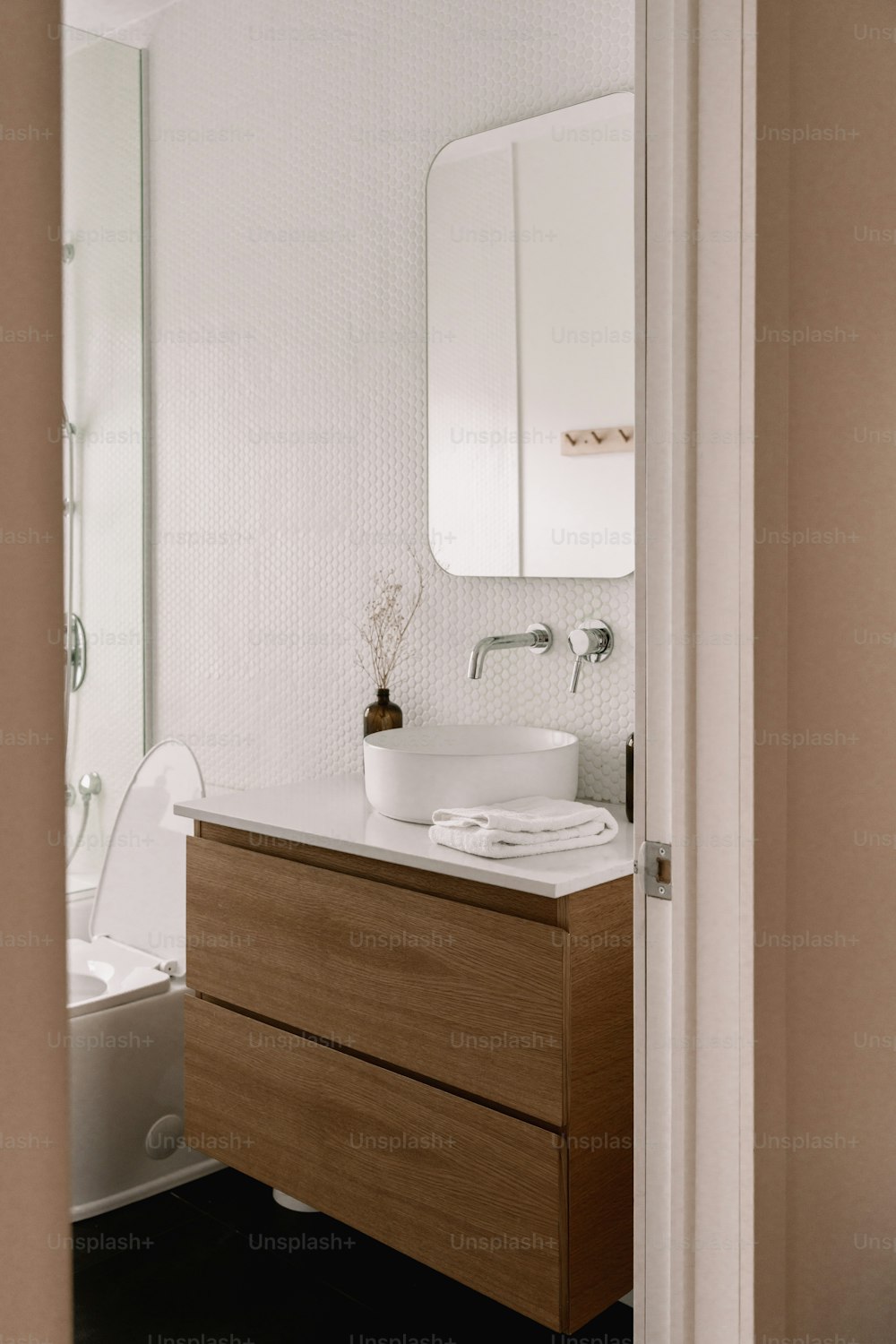 a bathroom with a sink, toilet and mirror