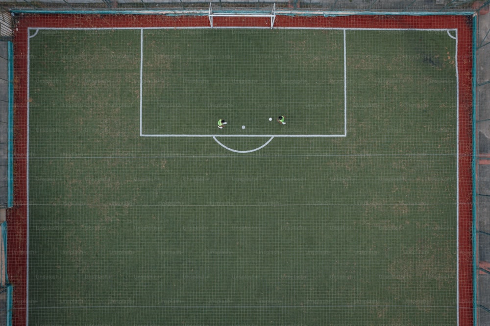 an aerial view of a soccer field with two players