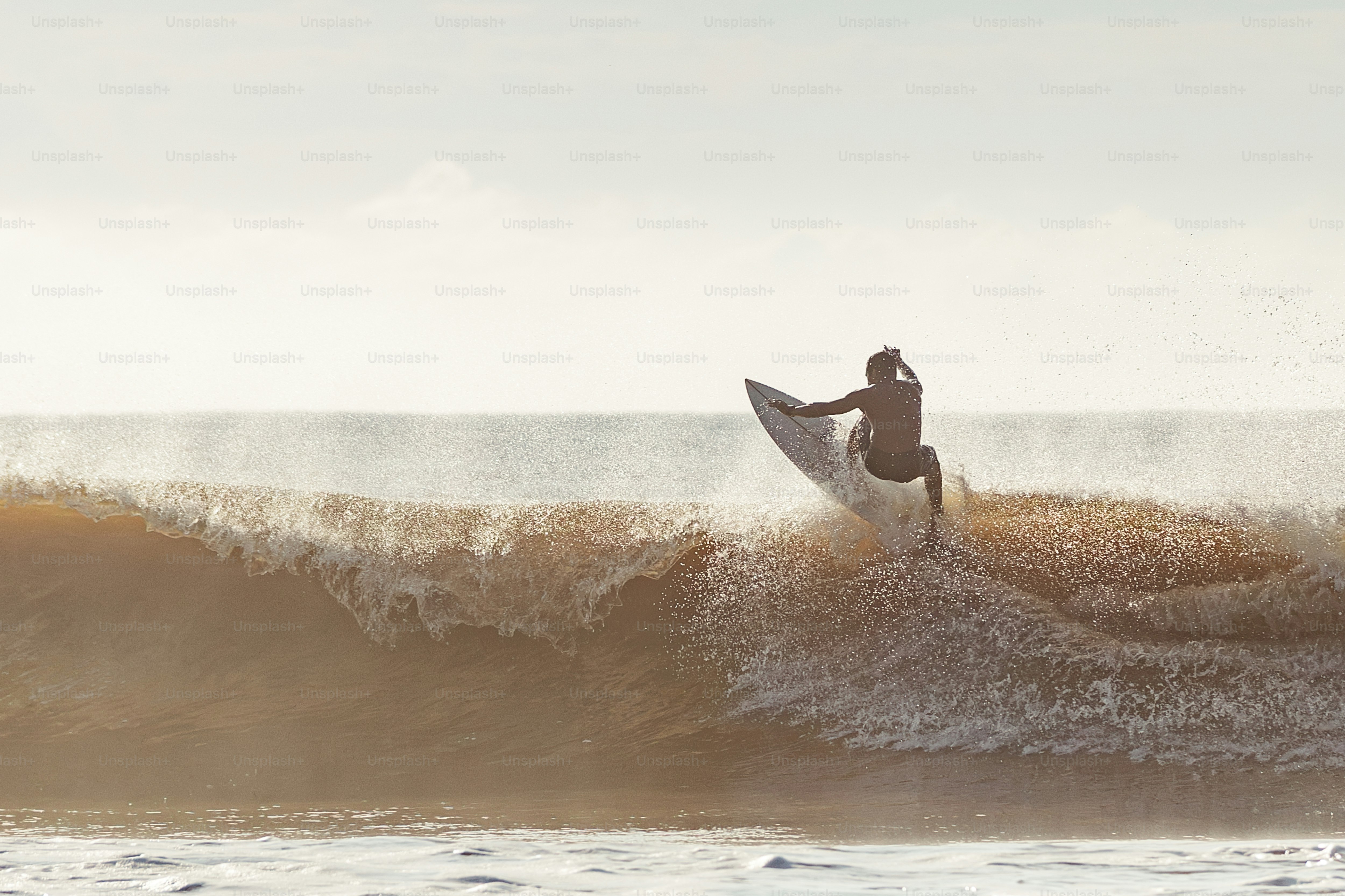 a man riding a wave on top of a surfboard