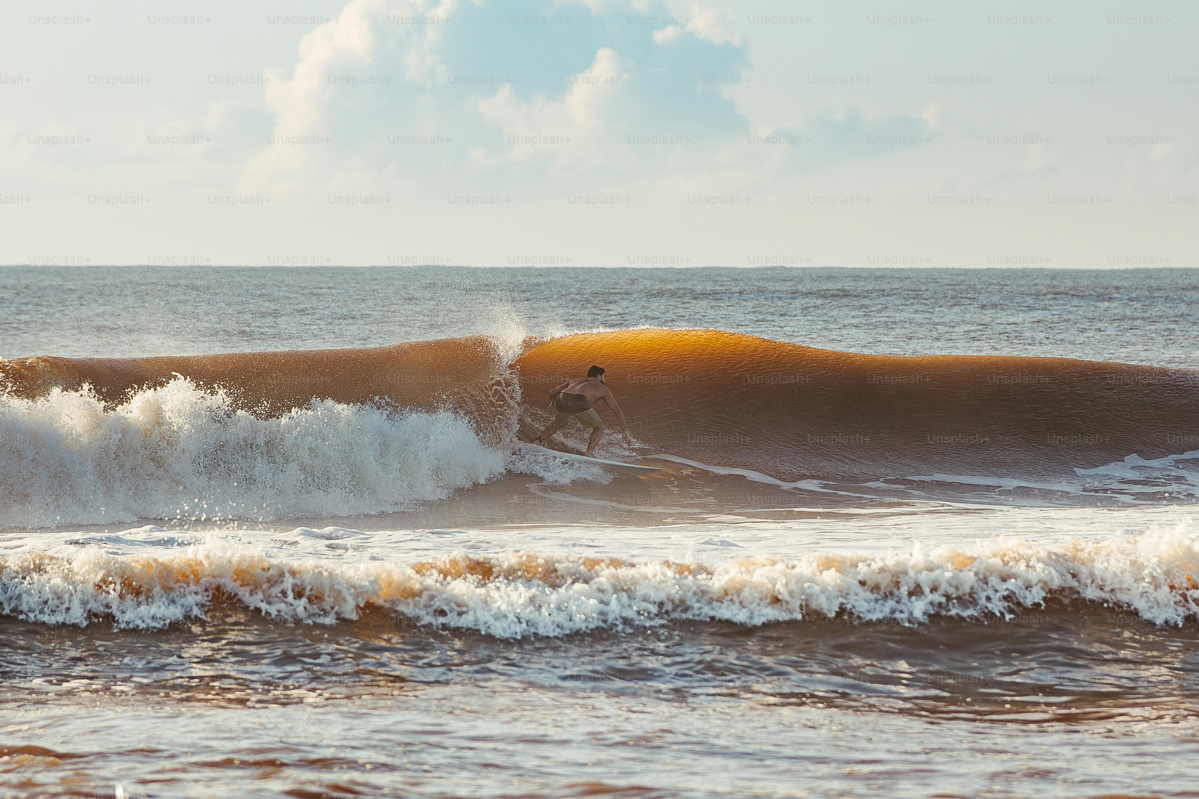 A person riding a wave on top of a surfboard photo – Beach Image on ...