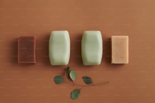 three soap bars sitting on top of a brown surface