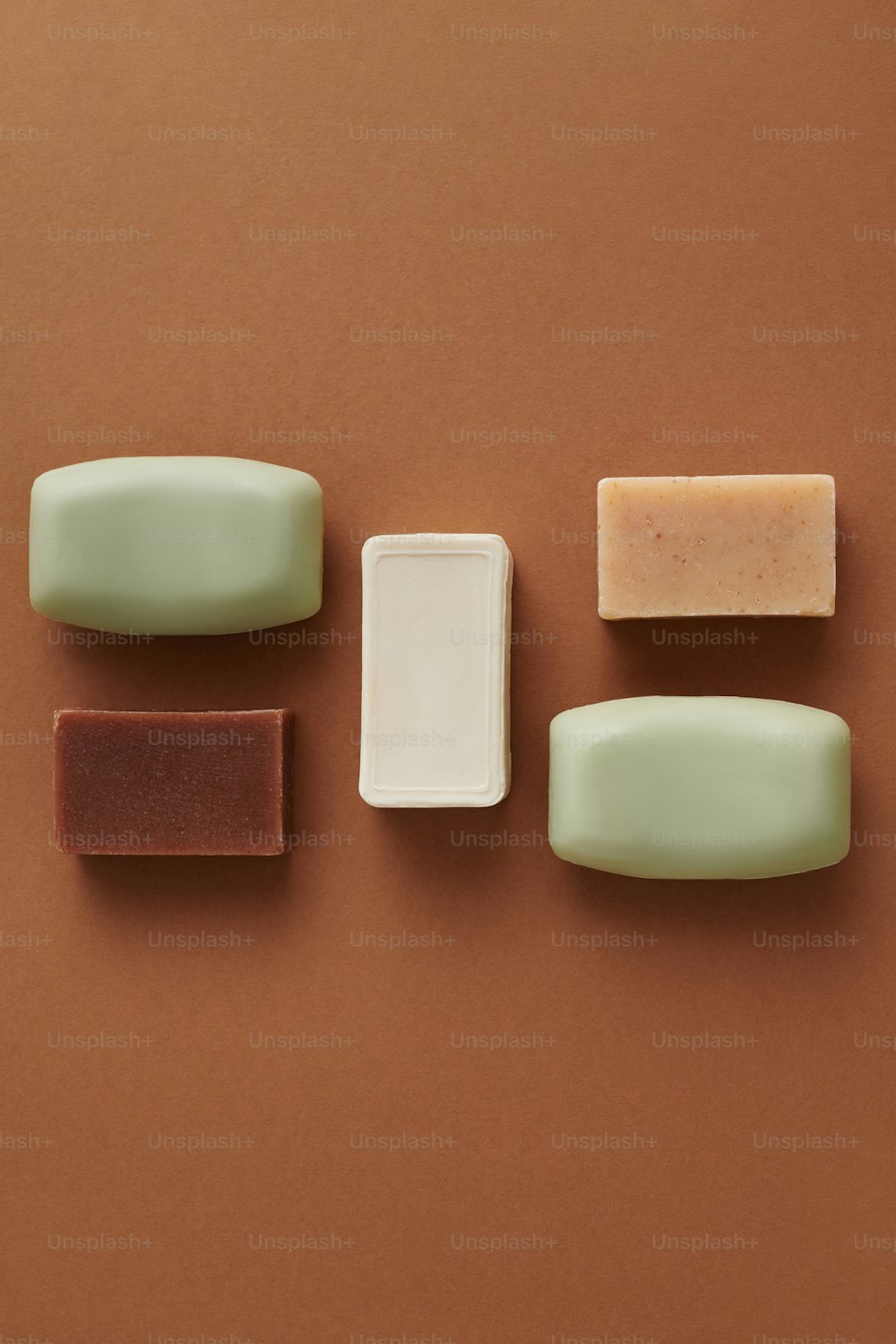 a group of soaps sitting on top of a brown surface