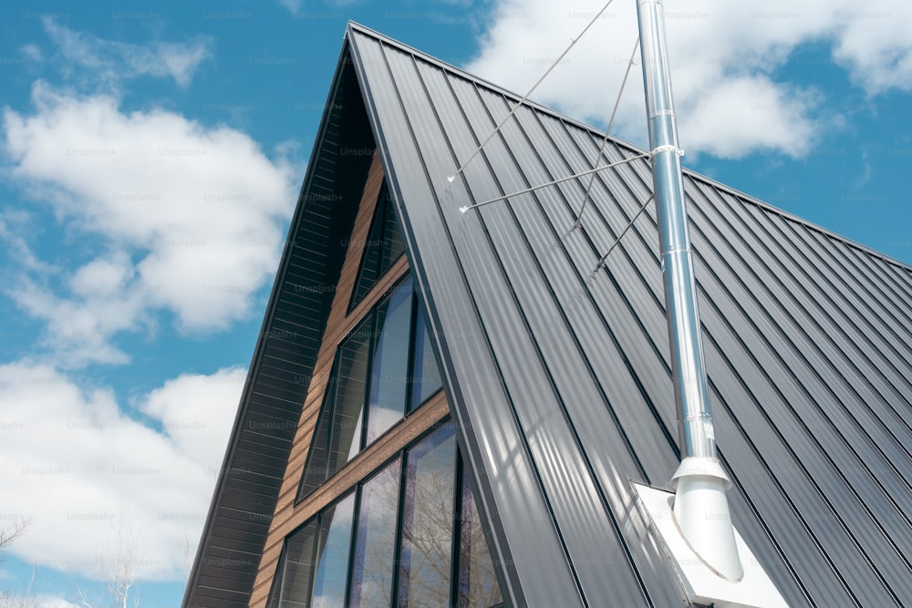 a large metal building with a weather vane on top of it