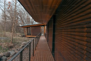 a wooden walkway leading to a building in the woods