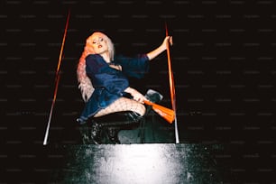 a woman sitting on top of a wooden table