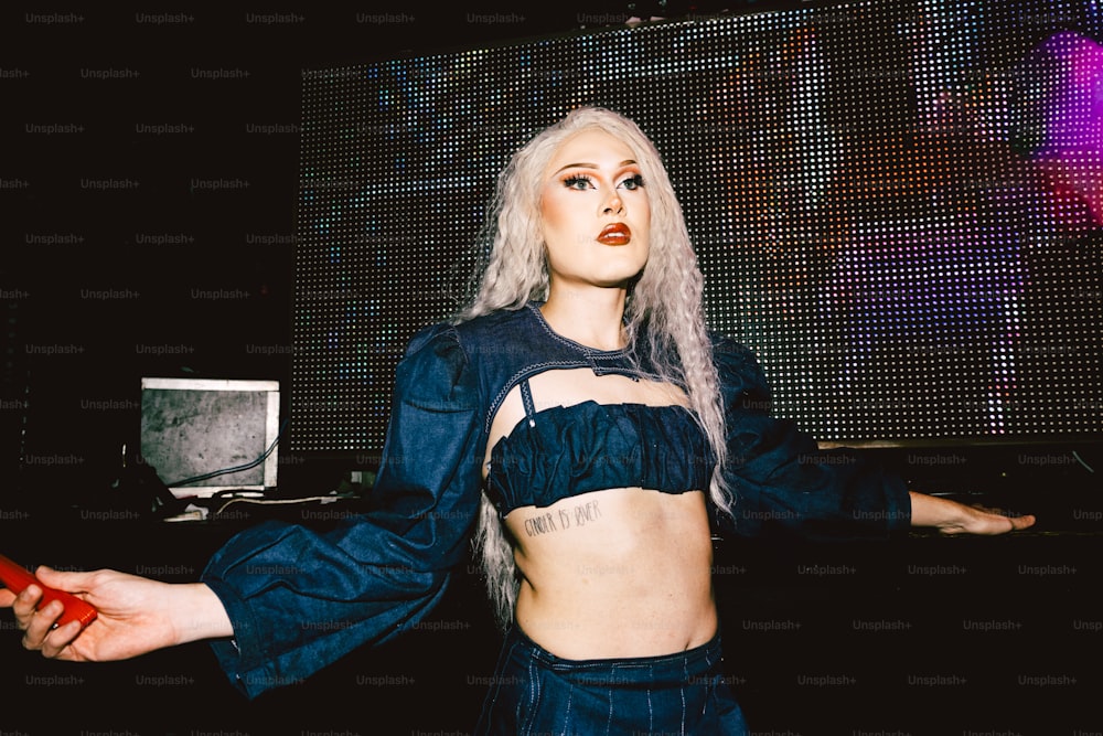 a woman with white hair wearing a crop top