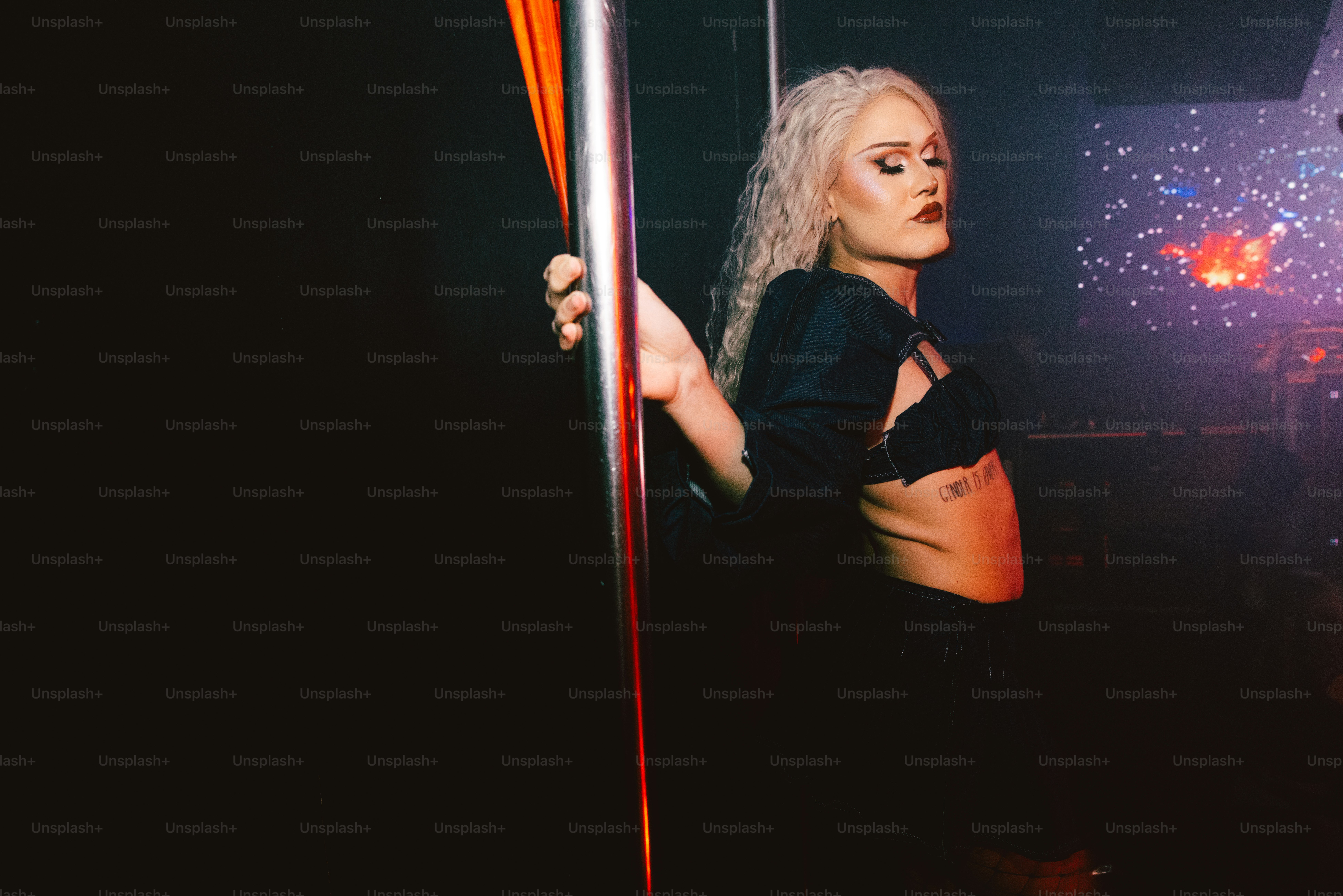 a woman holding a pole in a dark room