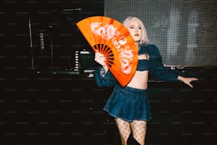 a woman in a short skirt holding a fan