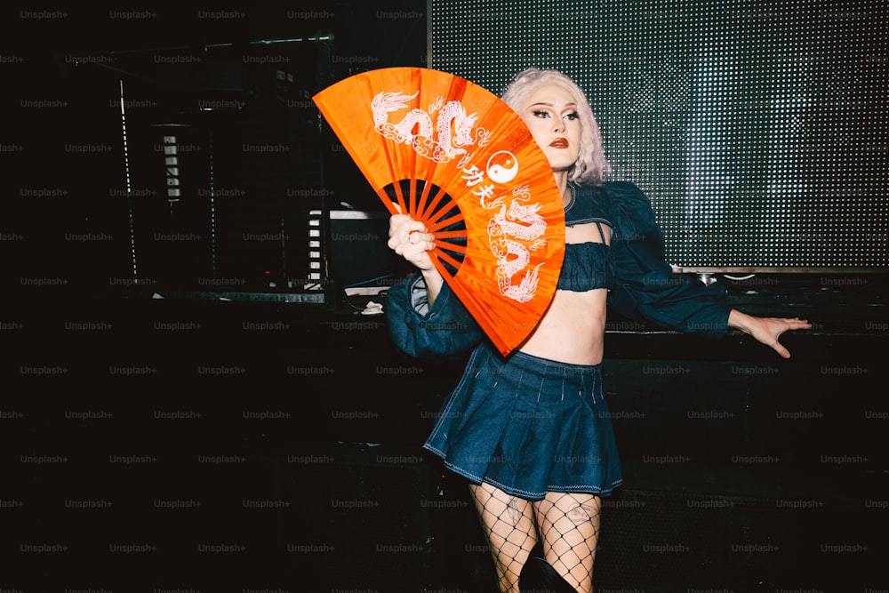 a woman in a short skirt holding a fan