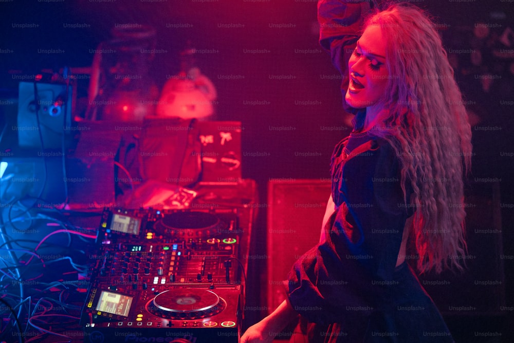 a woman standing in front of a dj set