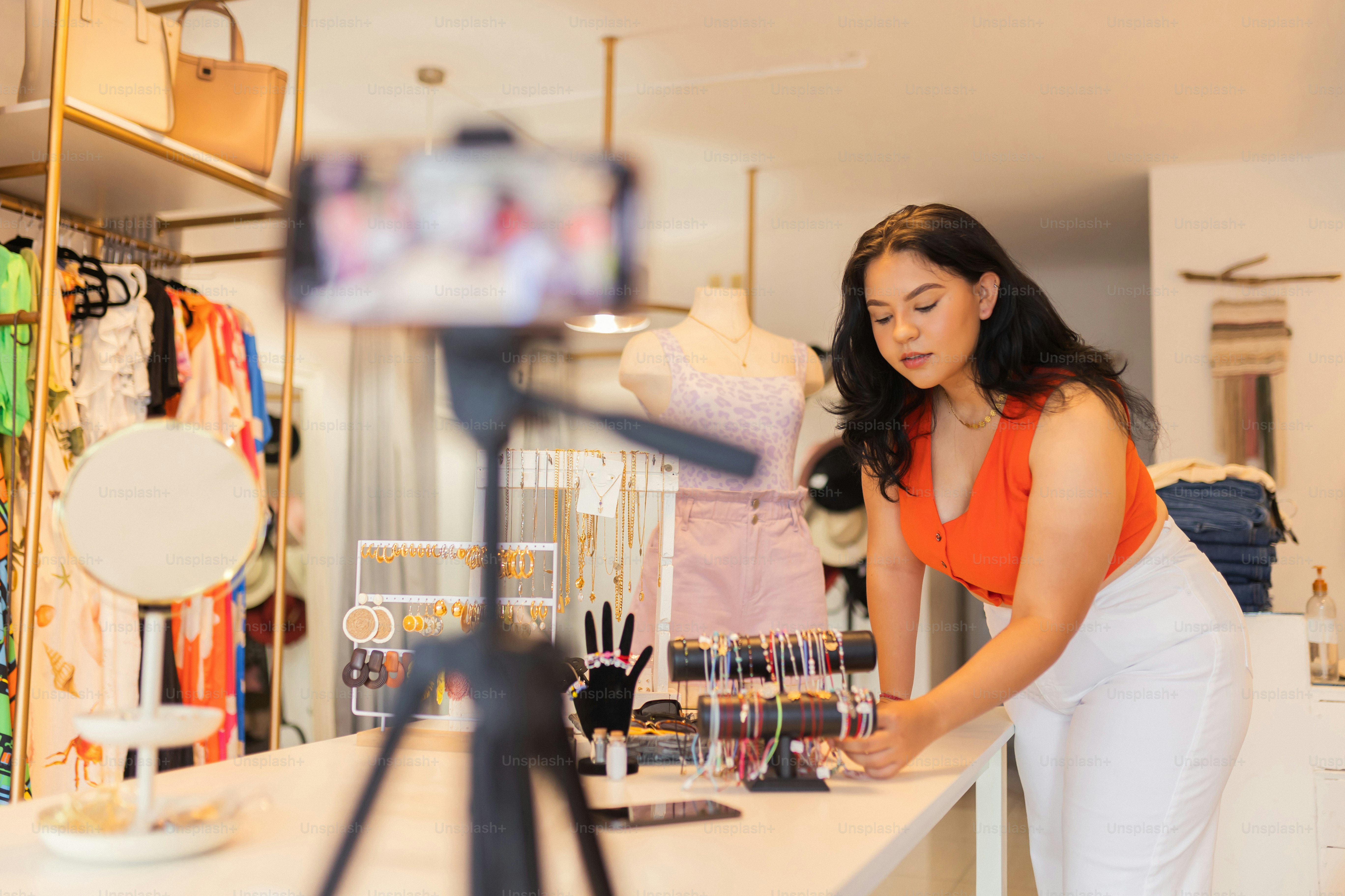 a woman standing in front of a display of clothes